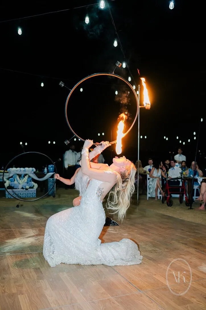 Fire performer entertaining guests on the dance floor at night