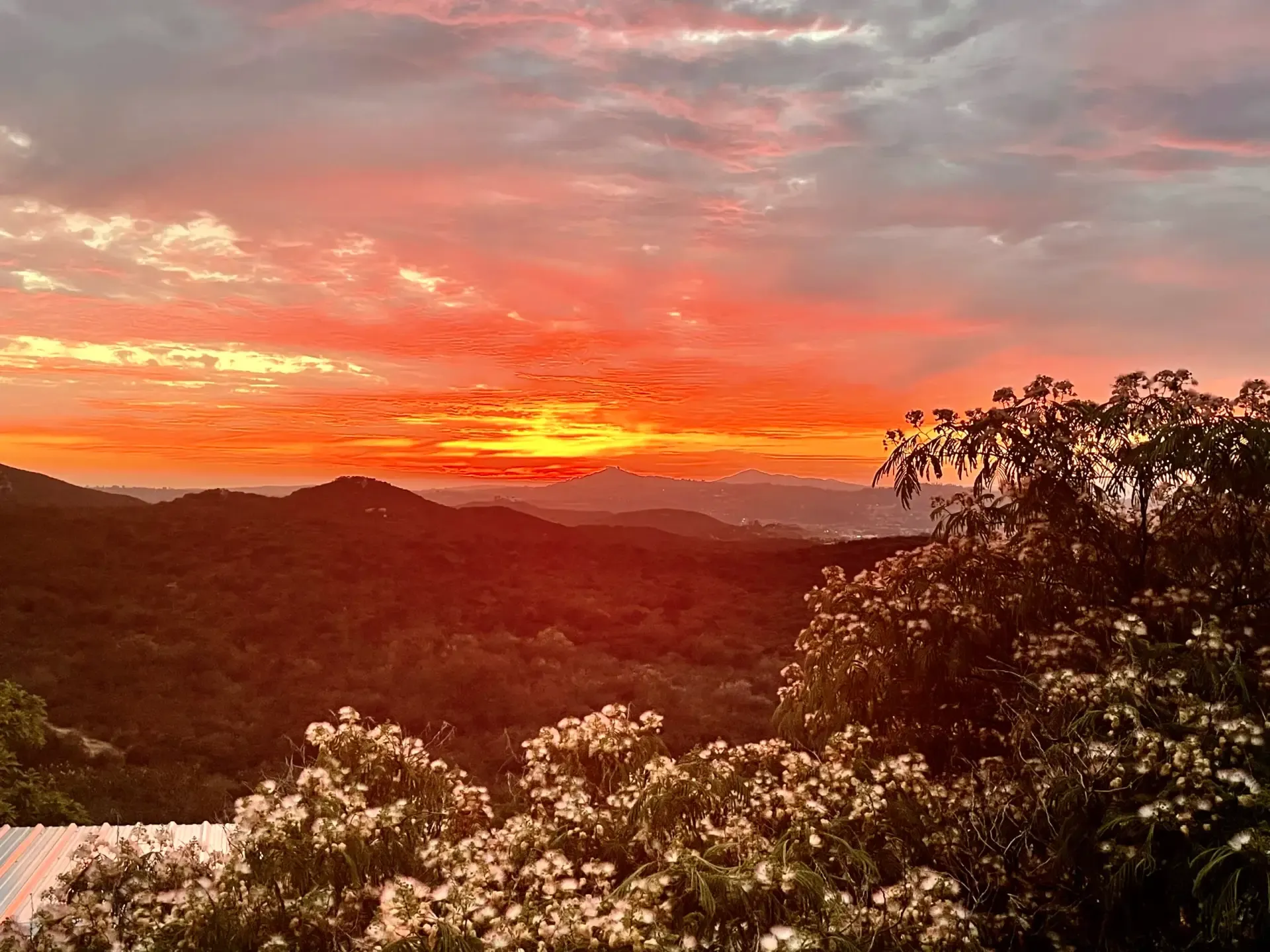 Fiery orange sunset over the Jamul hills seen from the terrace at Villa San Giovese