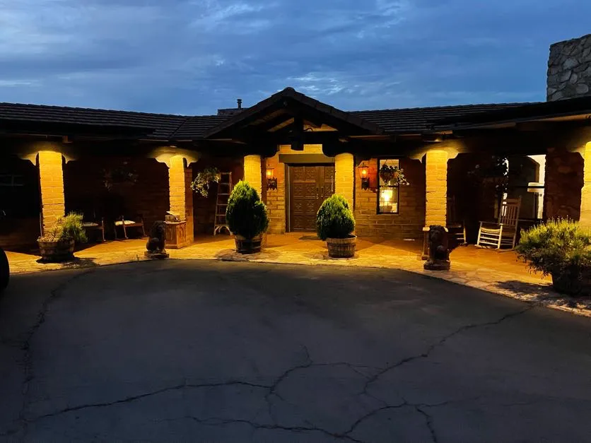 The villa entrance with lanterns glowing at dusk